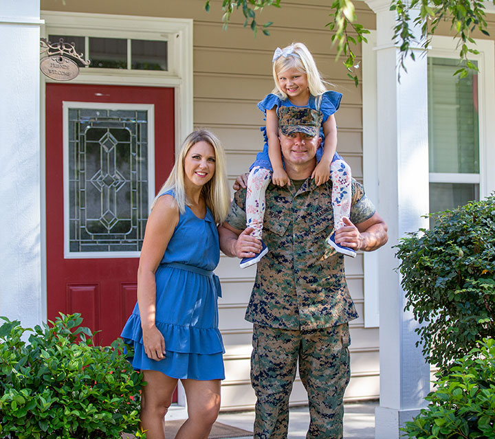Marine with his daughter and wife on their doorstep