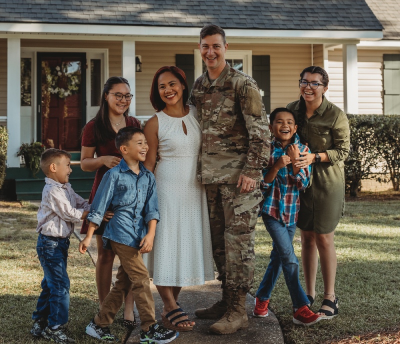 Service Member and family infront of house