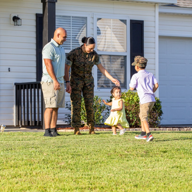 Service Member and family infront of house