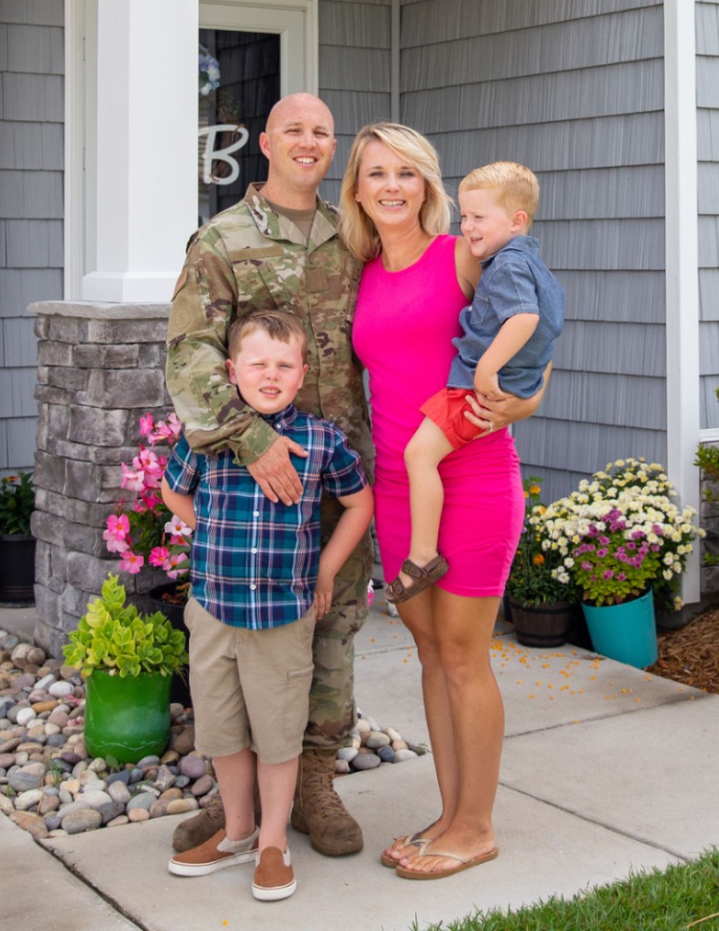 Service Member and family infront of house